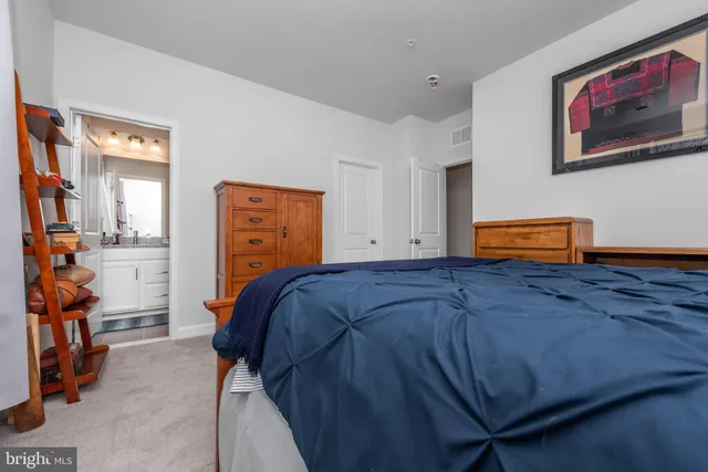 a bedroom with a bed and cabinets