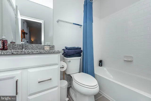 a bathroom with a toilet a sink and bathtub