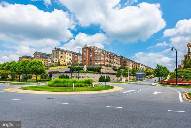 a street sign on a wall next to a road