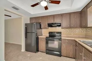 a kitchen with cabinets stainless steel appliances and a counter space