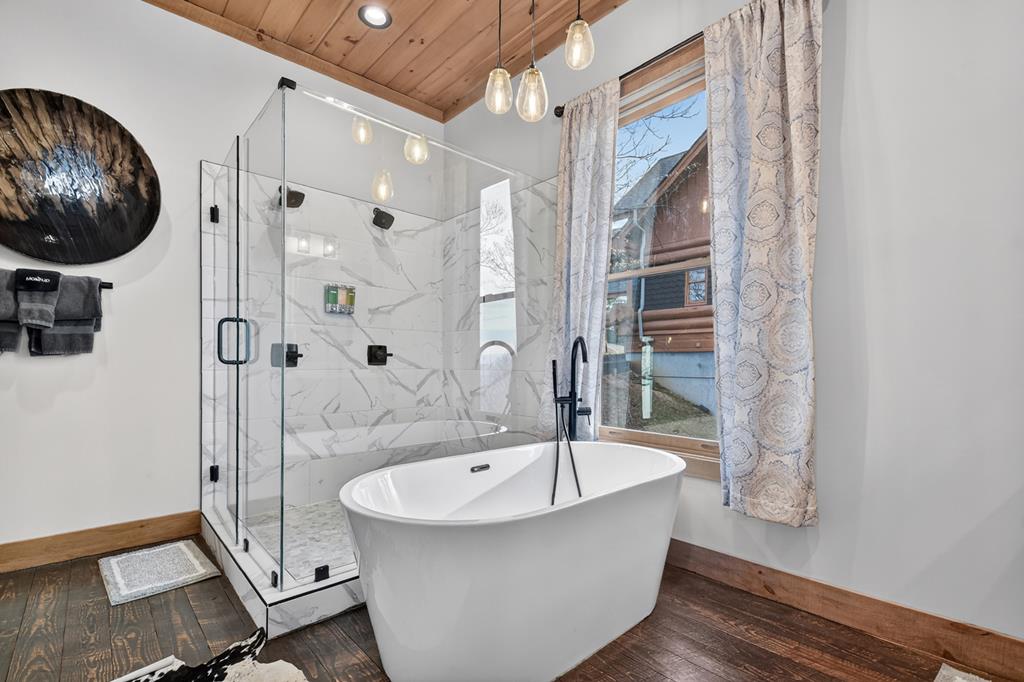 472 Overlook Drive Blue Ridge, GA 30513 - Photo 17 of 58 a bathroom with a bathtub and a shower