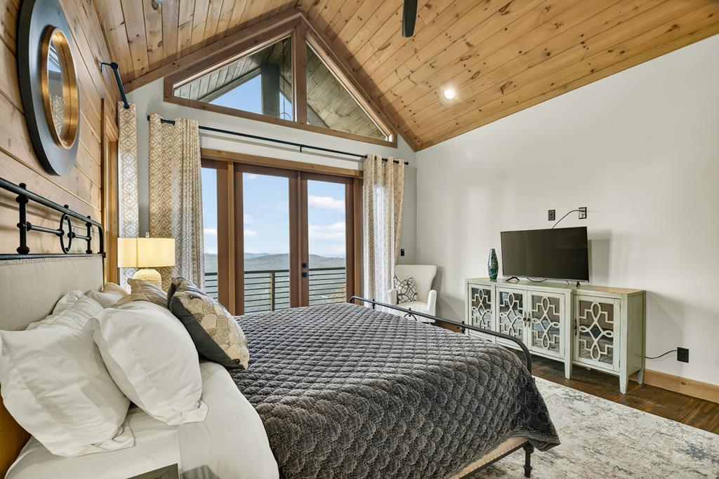472 Overlook Drive Blue Ridge, GA 30513 - Photo 29 of 58 a bedroom with a bed a flat screen tv and balcony view