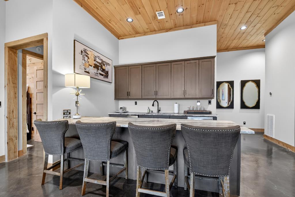 472 Overlook Drive Blue Ridge, GA 30513 - Photo 37 of 58 a kitchen with granite countertop a sink and chairs