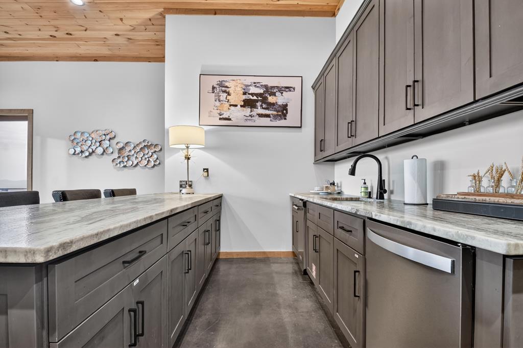 472 Overlook Drive Blue Ridge, GA 30513 - Photo 39 of 58 a kitchen with stainless steel appliances granite countertop a sink stove and cabinets