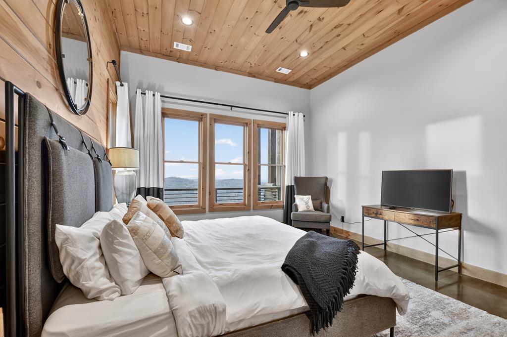 472 Overlook Drive Blue Ridge, GA 30513 - Photo 41 of 58 a bedroom with furniture and a flat screen tv