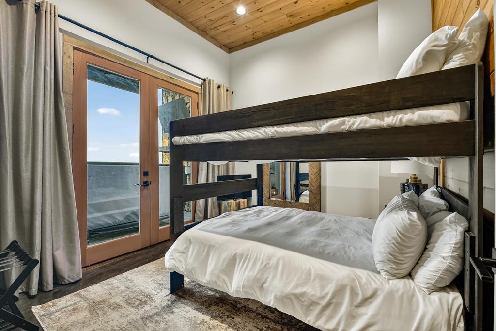 472 Overlook Drive Blue Ridge, GA 30513 - Photo 43 of 58 a bed sitting in a bedroom next to a window