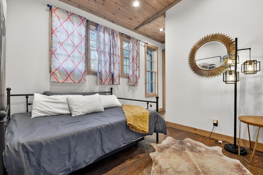 472 Overlook Drive Blue Ridge, GA 30513 - Photo 45 of 58 a bedroom with a bed and a chandelier