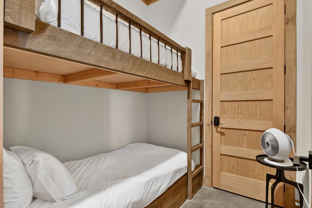 472 Overlook Drive Blue Ridge, GA 30513 - Photo 46 of 58 a bedroom with a bed and a chandelier