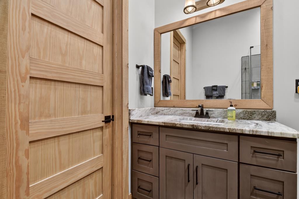 472 Overlook Drive Blue Ridge, GA 30513 - Photo 49 of 58 a bathroom with a granite countertop sink and a mirror