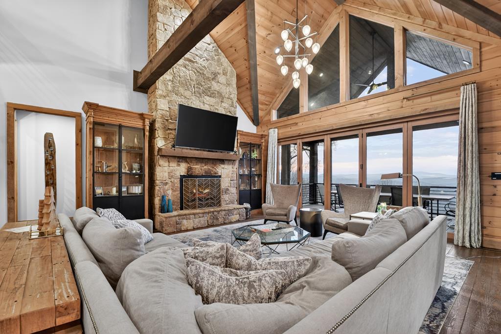 472 Overlook Drive Blue Ridge, GA 30513 - Photo 5 of 58 a living room with furniture a fireplace a flat screen tv and a large window