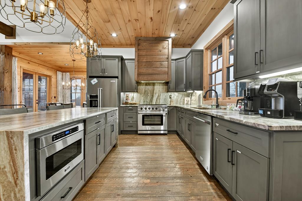 472 Overlook Drive Blue Ridge, GA 30513 - Photo 8 of 58 a large kitchen with stainless steel appliances granite countertop a lot of counter space and wooden floors
