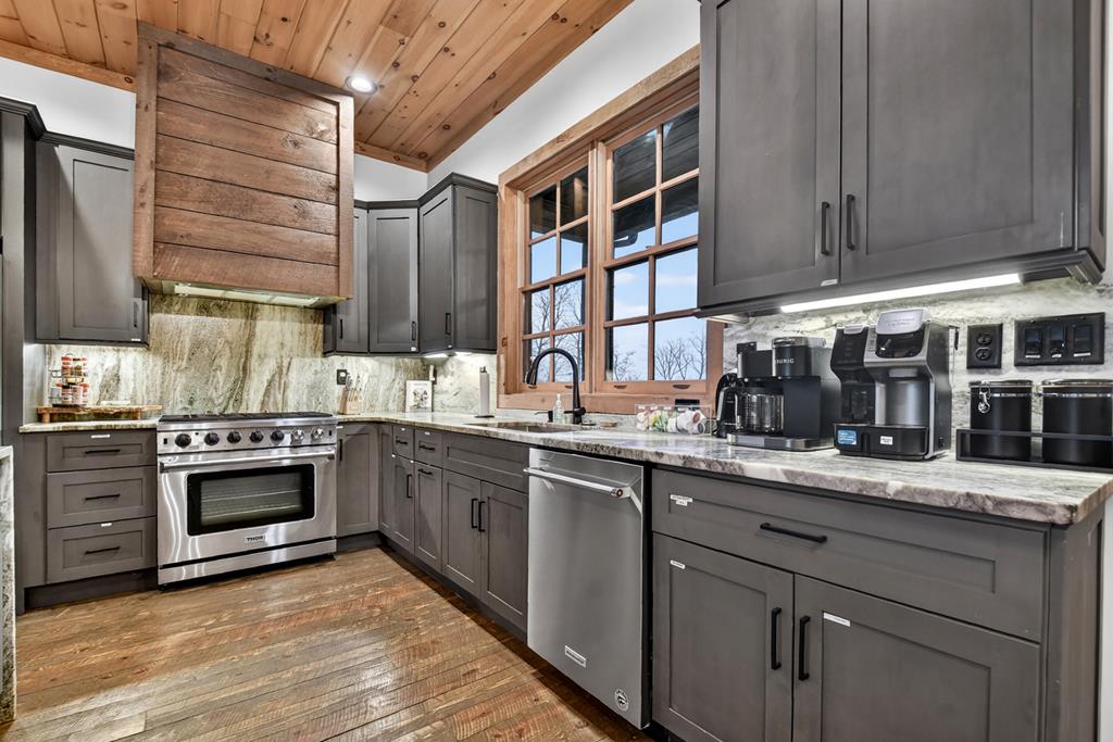 472 Overlook Drive Blue Ridge, GA 30513 - Photo 10 of 58 a kitchen with stainless steel appliances granite countertop a sink and wooden cabinets