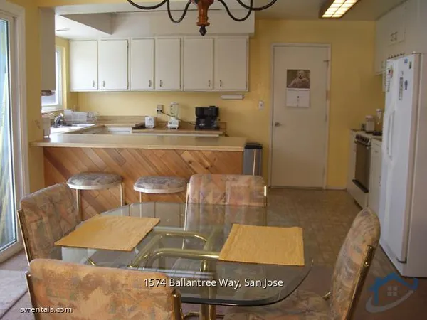 a kitchen with stainless steel appliances granite countertop a sink and a refrigerator