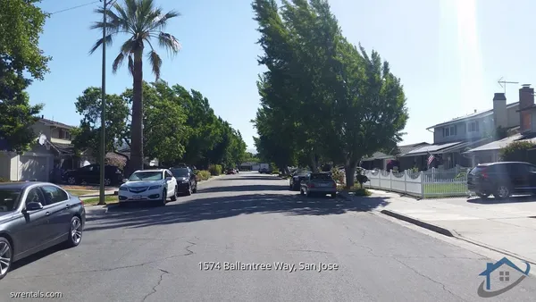 a row of palm trees in front of a house