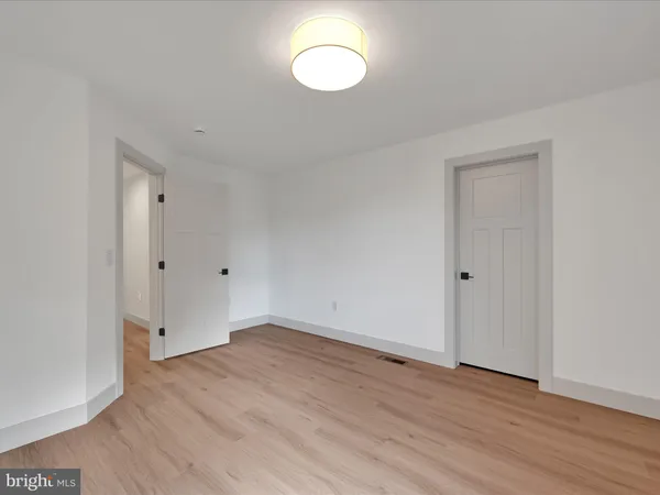 a view of a room with wooden floor and window