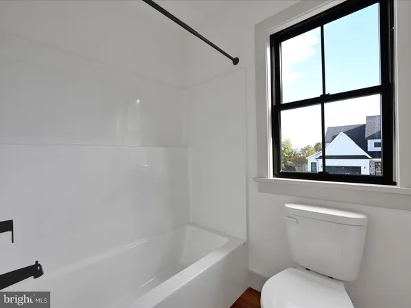 a bathroom with a toilet and a bathtub