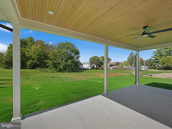 a view of a backyard with table and chairs under an umbrella