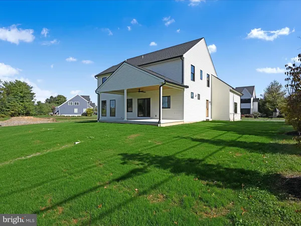a view of a house with a yard and sitting area