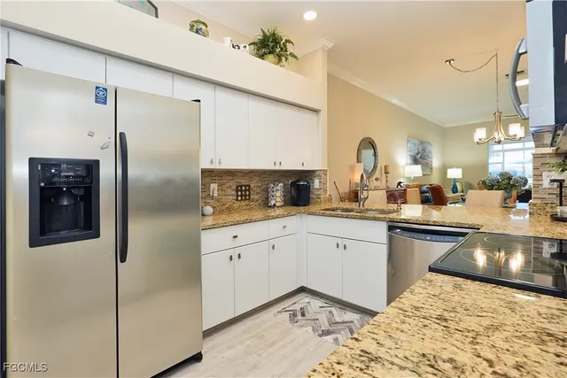 a kitchen with a refrigerator sink and cabinets