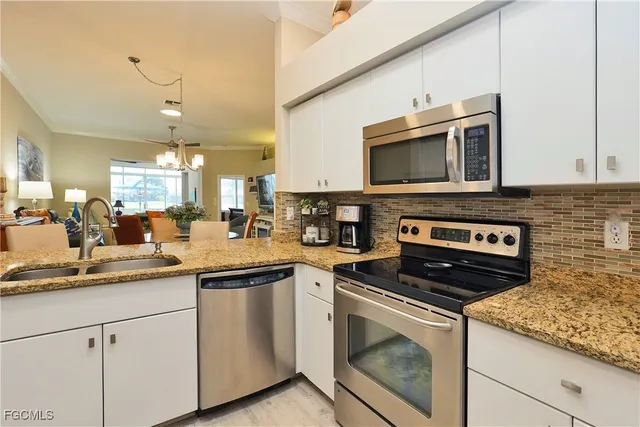 a kitchen with cabinets stainless steel appliances and a sink