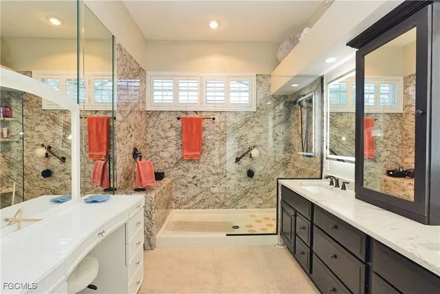 a bathroom with a tub sink and mirror
