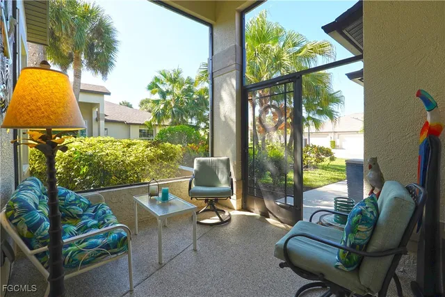 a view of a chairs and table in patio with a backyard