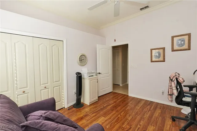 a bedroom with furniture and wooden floor