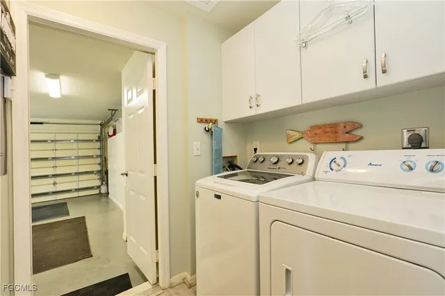 a view of washer and dryer with kitchen in the background