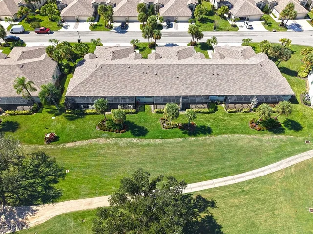 a aerial view of a house with a yard and potted plants