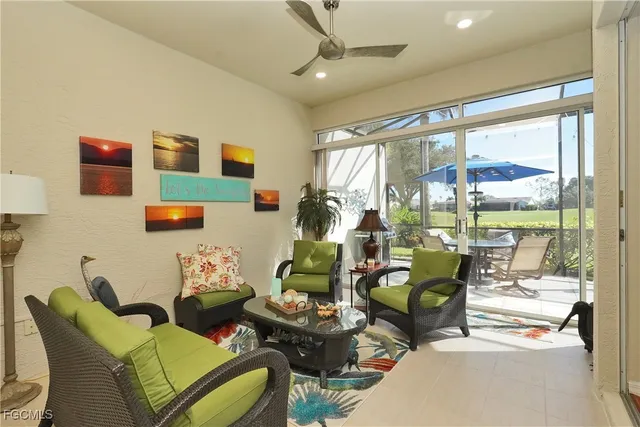 a living room with furniture and a floor to ceiling window