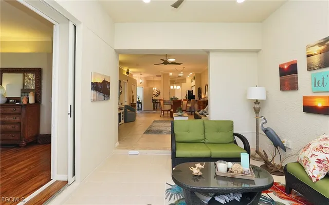 a living room with furniture and a chandelier