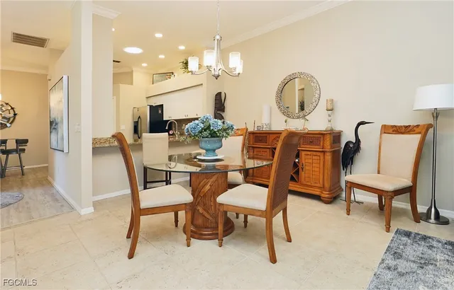 a dining room with furniture and a mirror