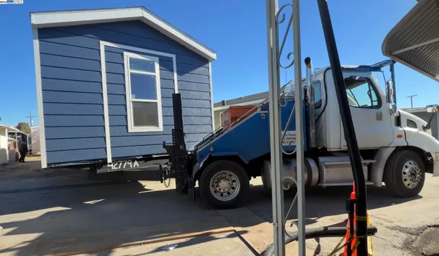 a view of a house with a car park side of road