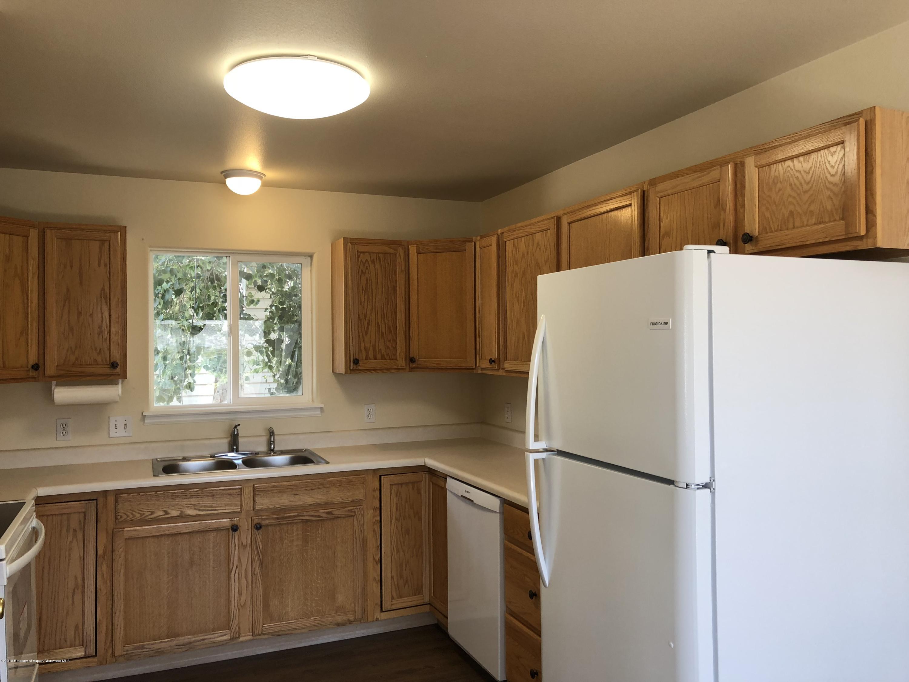 403 Columbine Drive Rifle, CO 81650 - Photo 8 of 17 a white refrigerator freezer sitting inside of a kitchen