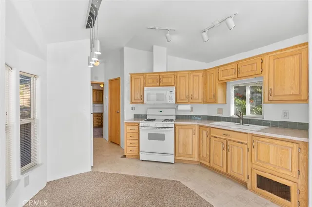 a kitchen with stainless steel appliances granite countertop a stove and a refrigerator