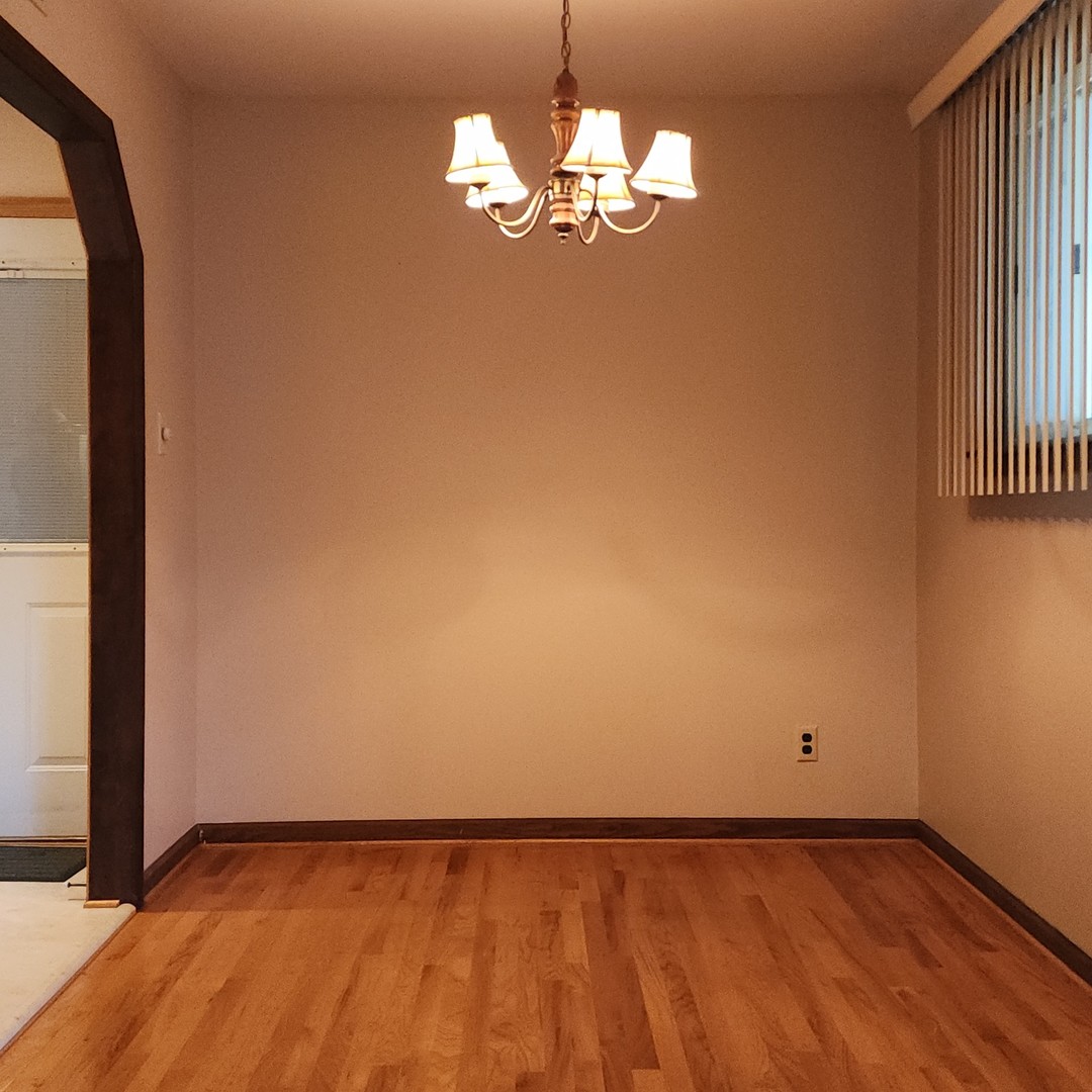 4605 West 84th Place Chicago, IL 60652 - Photo 10 of 31 wooden floor in an empty room with a window