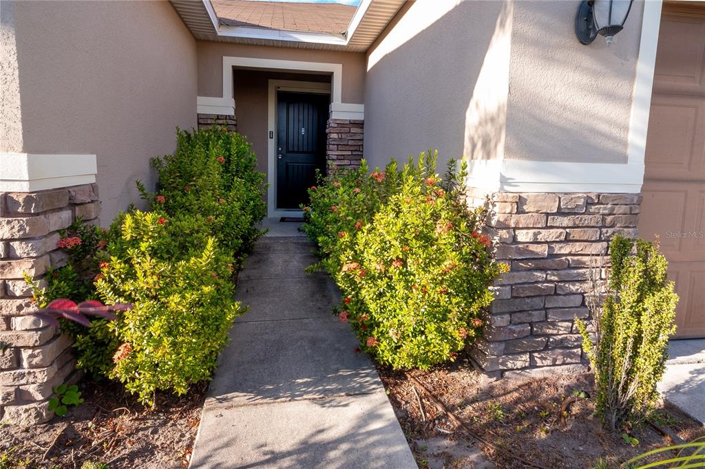 4563 Orchard Grove Road St. Cloud, FL 34772 - Photo 8 of 51 a view of a pathway with flower pots