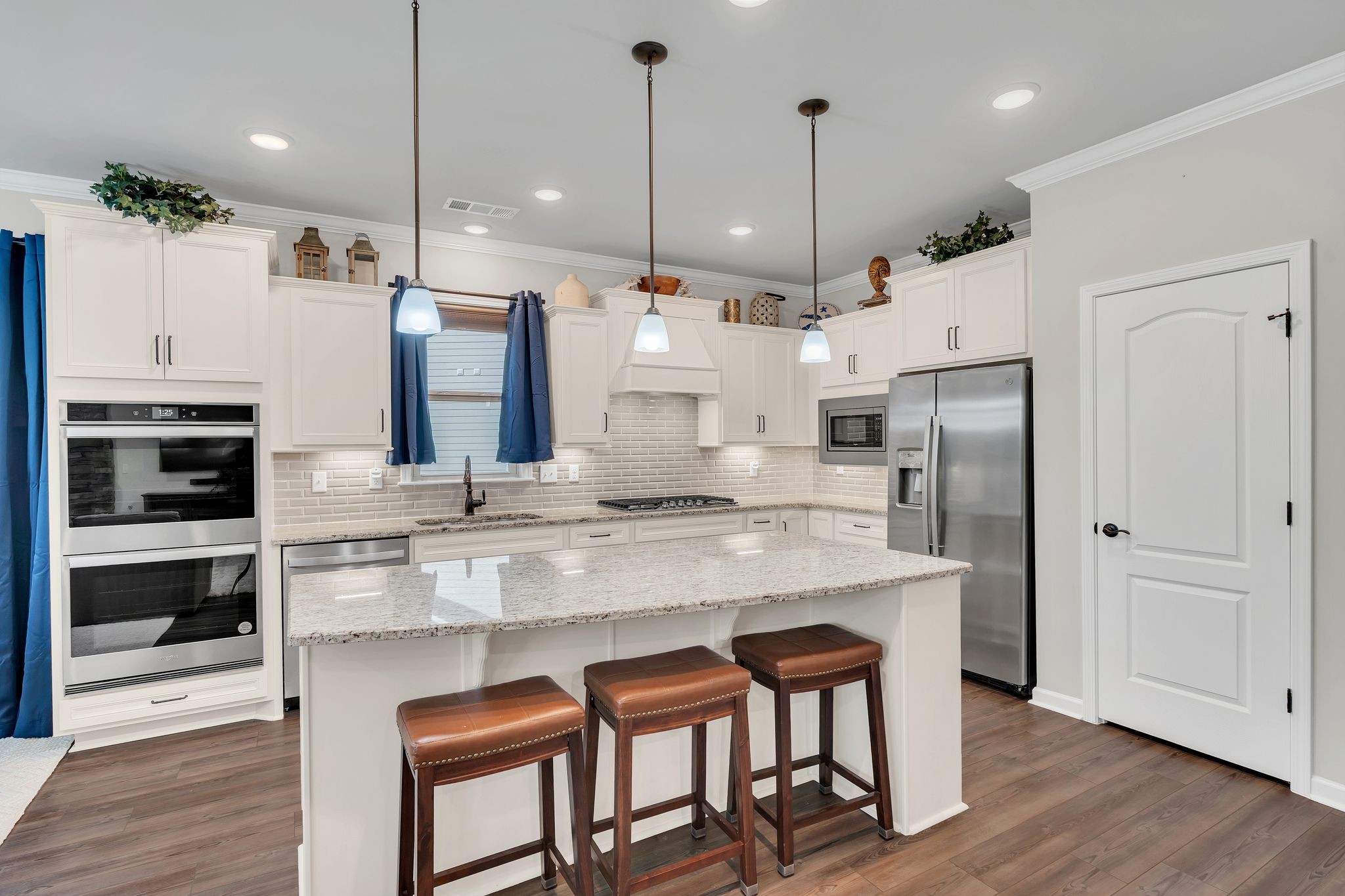 2061 Hardin Place Spring Hill, TN 37174 - Photo 11 of 65 a kitchen with stainless steel appliances granite countertop a refrigerator a oven and white cabinets with wooden floors