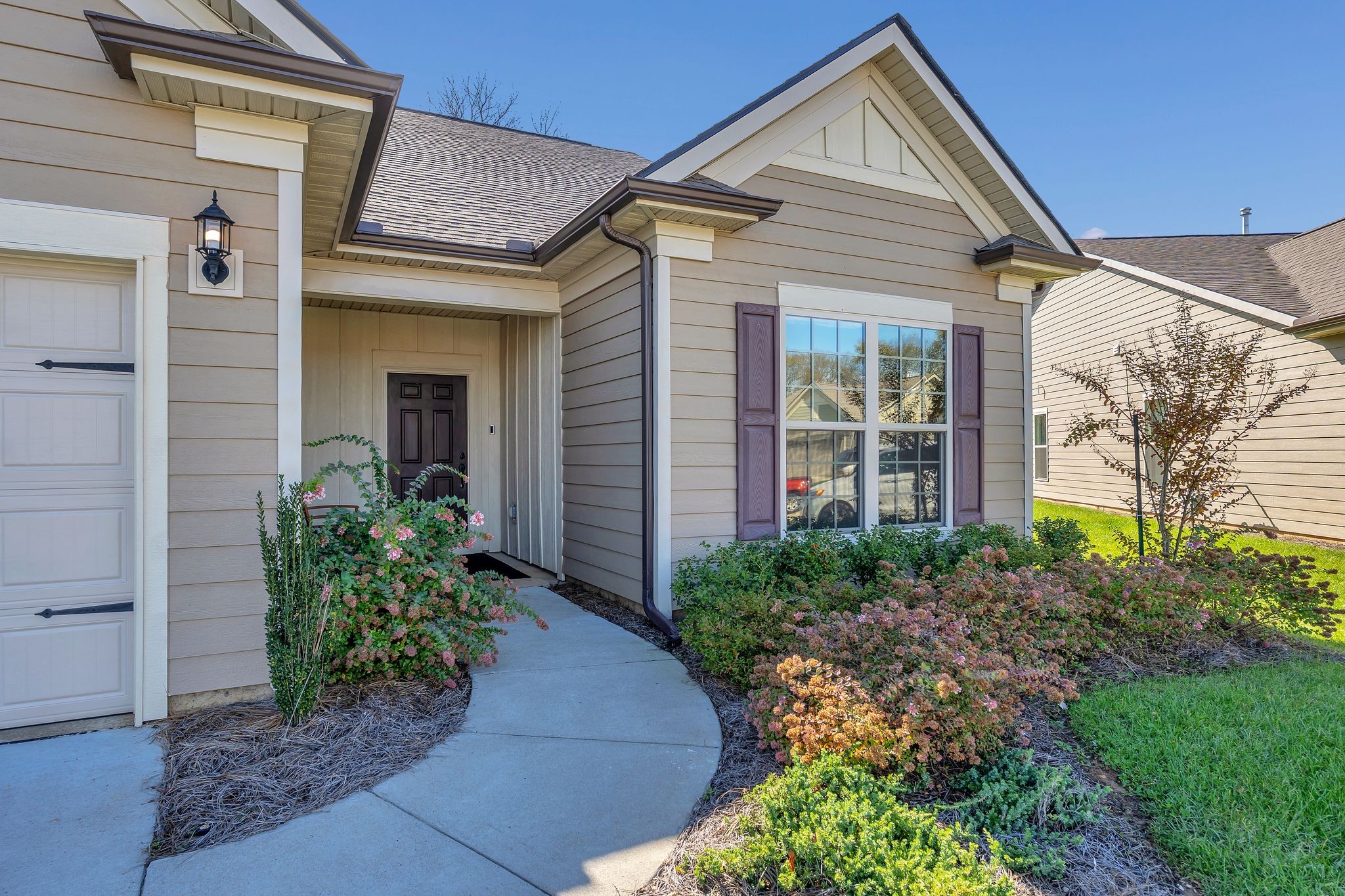 2061 Hardin Place Spring Hill, TN 37174 - Photo 3 of 65 a view of a house with brick walls plants and large tree