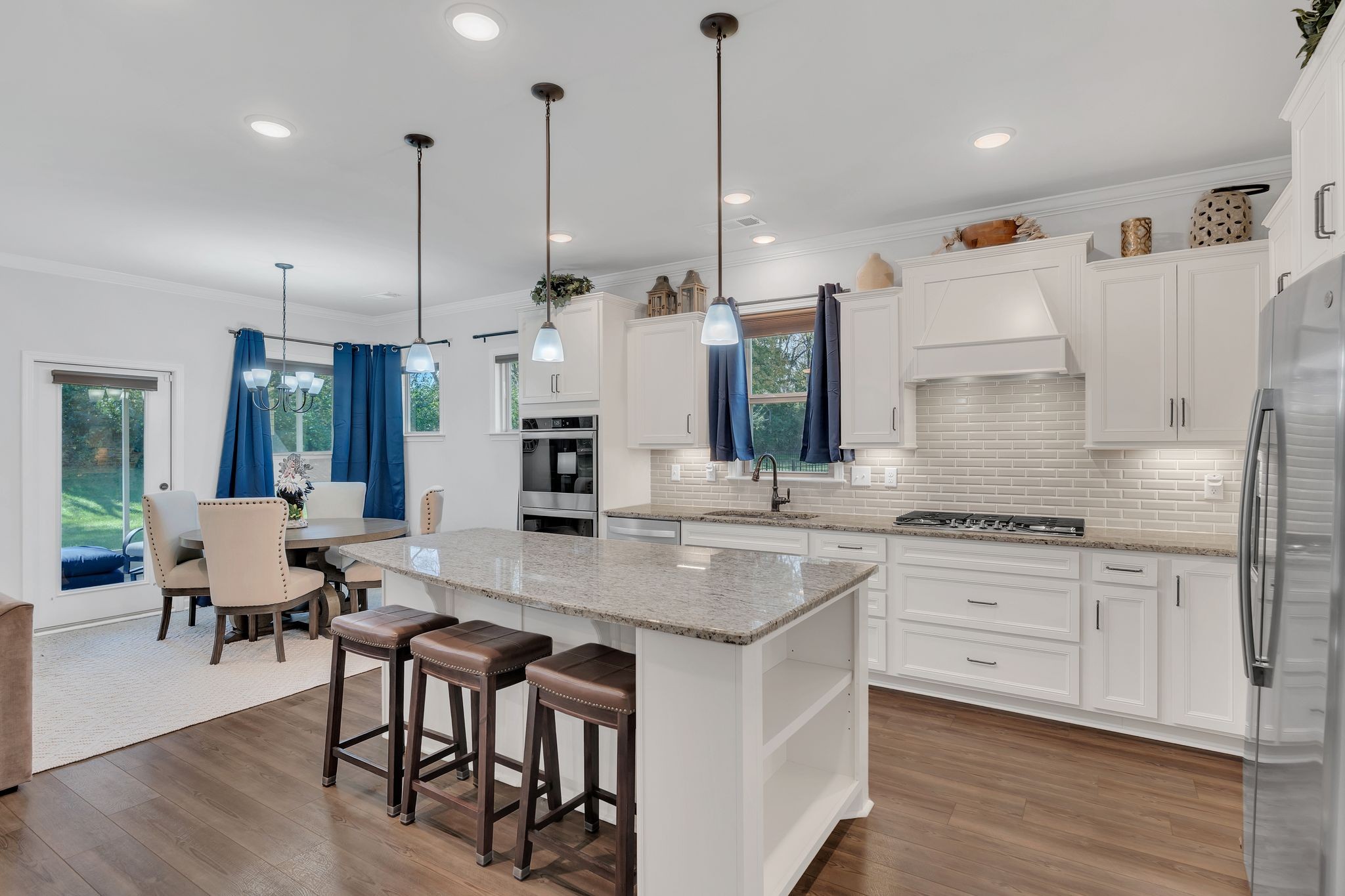 2061 Hardin Place Spring Hill, TN 37174 - Photo 10 of 65 a large kitchen with kitchen island a large island a sink stainless steel appliances and cabinets