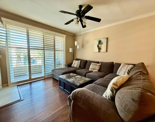 a living room with furniture and wooden floor