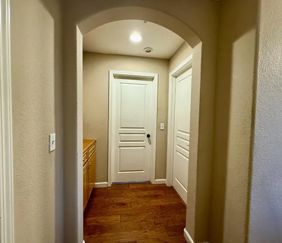 a view of a hallway with wooden floor