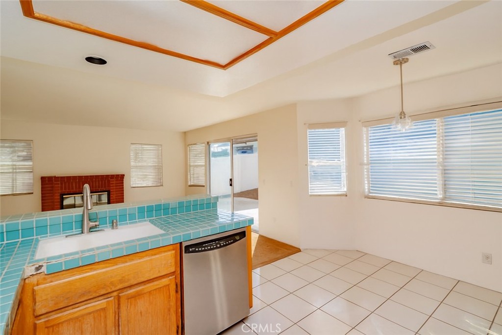 2038 Ridgeline Avenue Vista, CA 92081 - Photo 11 of 32 a kitchen with granite countertop a sink and cabinets