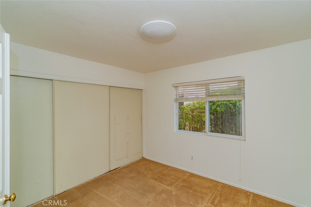 2038 Ridgeline Avenue Vista, CA 92081 - Photo 15 of 32 a view of an empty room with wooden floor and a window