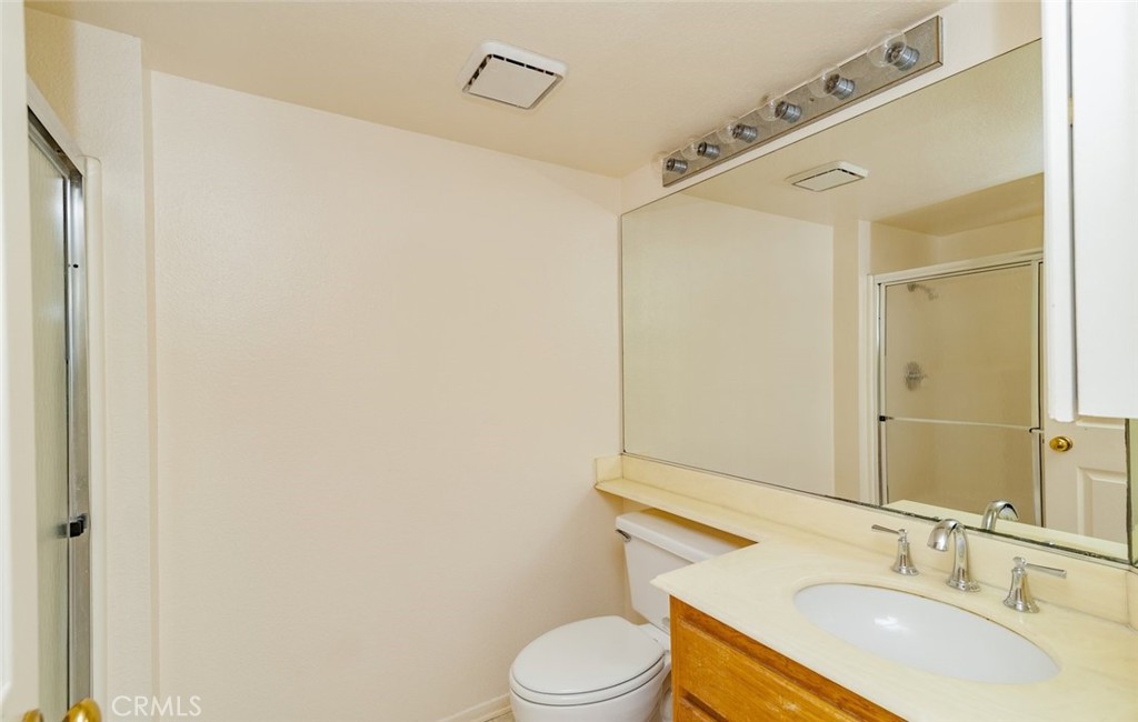 2038 Ridgeline Avenue Vista, CA 92081 - Photo 17 of 32 a bathroom with a sink toilet and shower