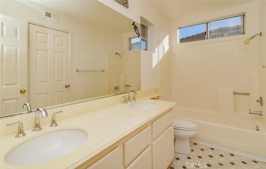 2038 Ridgeline Avenue Vista, CA 92081 - Photo 27 of 32 a bathroom with a sink toilet tub and shower