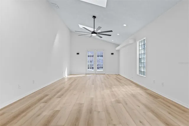 wooden floor in an empty room with a window