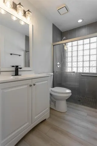 a bathroom with a toilet a sink and mirror