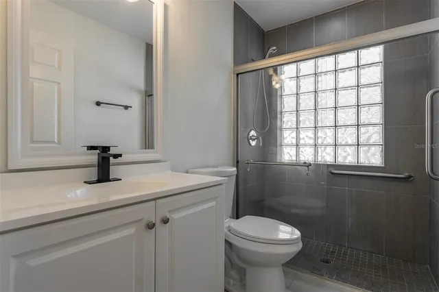 a bathroom with a sink toilet and a window