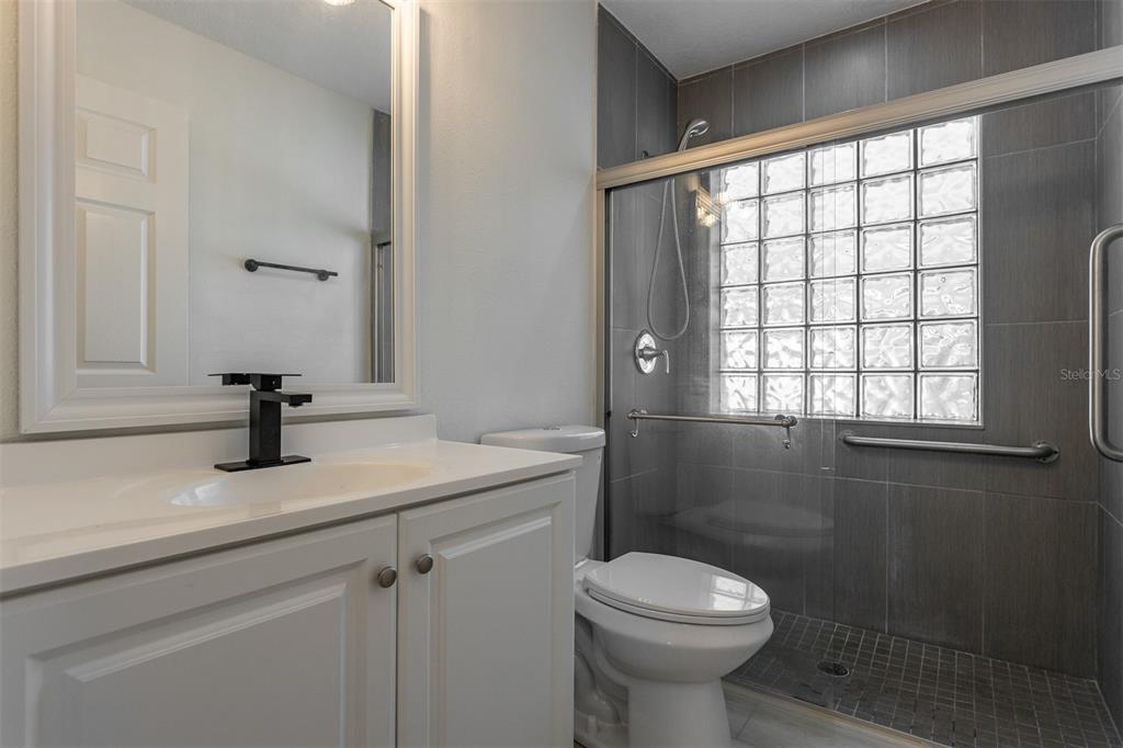 1734 Powder Ridge Drive Valrico, FL 33594 - Photo 19 of 32 a bathroom with a sink toilet and a window